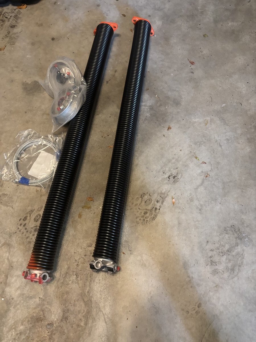 New torsion springs fitted above a garage door